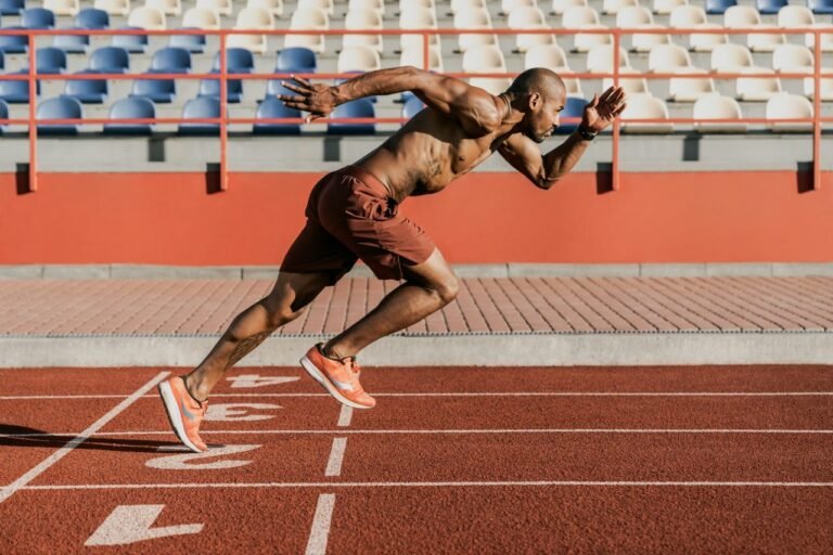 side-view-of-an-athlete-starting-his-sprint-on-an-all-weather-running-track