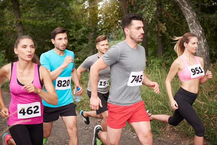 runners-competing-in-race-outdoors-on-trail-with-race-numbers